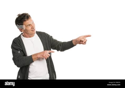 Portrait Of A Happy Senior Man Pointing Somewhere Isolated On White