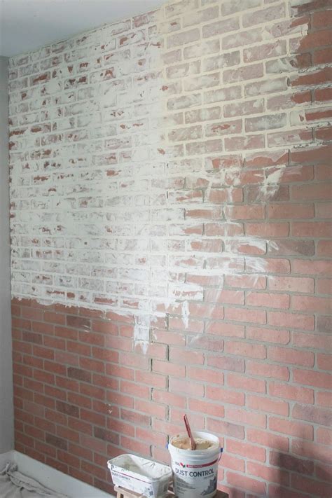 Two Buckets Of Paint Sitting On Top Of A Table In Front Of A Brick Wall