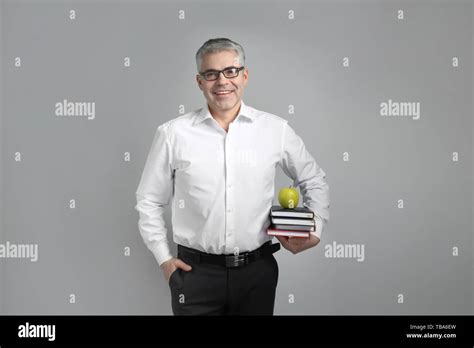 Mature Male Teacher On Grey Background Stock Photo Alamy