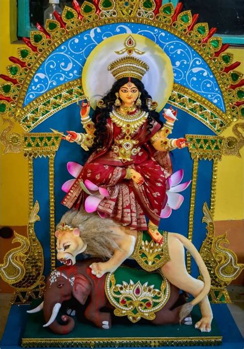 A Statue Of The Hindu Goddess Sitting On Top Of A Lion