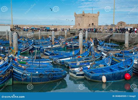 The Blue Fishing Boats And In The Background The Tower Of The Sqala