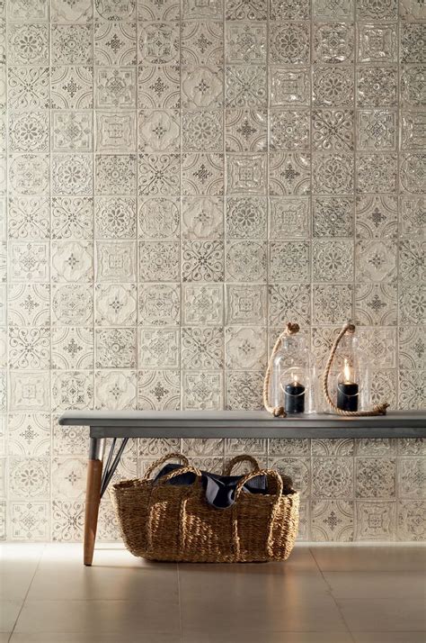 A Table With A Basket On It Next To A Wallpapered Wall And A Candle