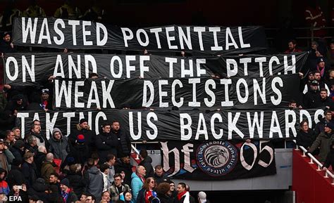 Roy Hodgson And Crystal Palace Players Watch On As Eagles Fans Hold Up