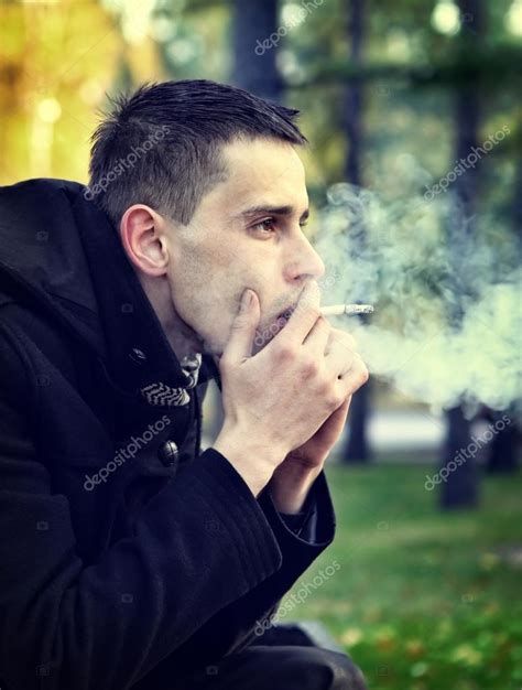 Sad Man with Cigarette Stock Photo by ©sabphoto 82959580