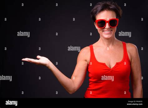 Mature Beautiful Woman With Short Hair Against Black Background Stock Photo Alamy