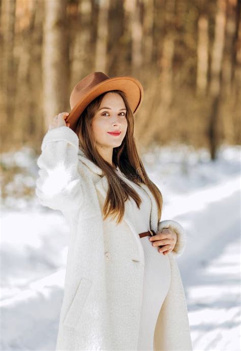 Amazing Pregnant Woman In A Brown Hat And Light Coat Stock Image