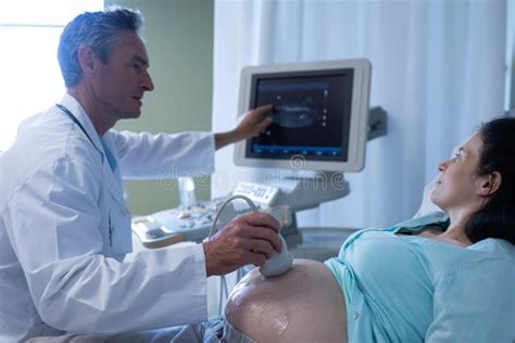 Doctor Doing Ultrasound Scan For Pregnant Woman In Hospital Stock Photo