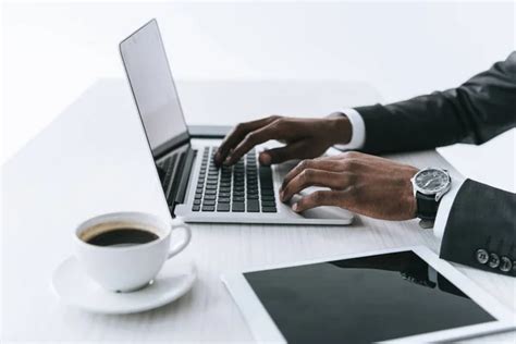 African American Businessman Typing On Laptop Stock Photo