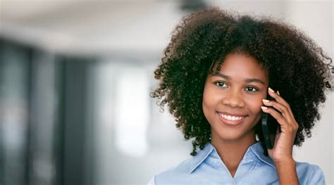 Premium Photo Portrait Of Smiling African Woman Talking On Mobile