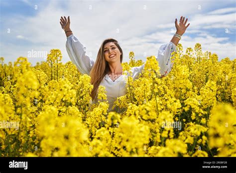 Portrait Of A Beautiful Blonde Hispanic Woman In A Blooming Canola Field Stock Photo Alamy
