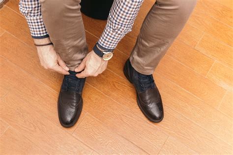 Free Photo Crop Businessman Tying Laces