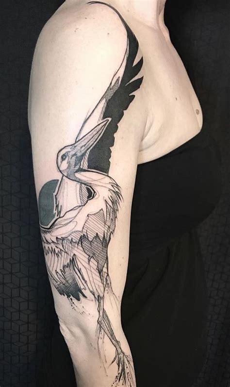 A Woman With A Bird Tattoo On Her Arm