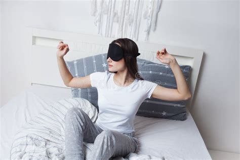 Young Woman Woke Up In The Morning In Bed Wearing A Sleep Mask Good