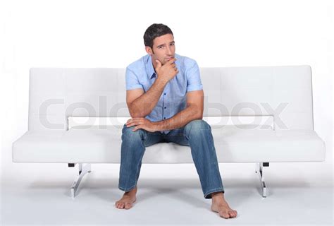 Mann Sitzt Auf Einem Sofa Stock Bild Colourbox