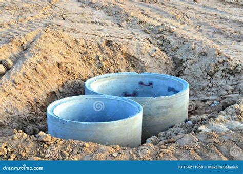 Installation Of Concrete Sewer Wells In The Ground At The Construction