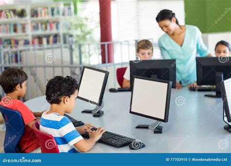 Children Using Computers As Teacher Teaching Them Stock Image Image