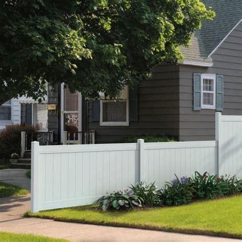 A White Picket Fence In Front Of A House