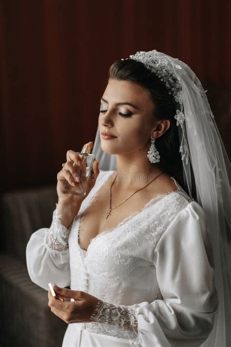 Details Wedding Accessories The Brunette Bride Is Dressed In A Peignoir Holds Perfume In Her