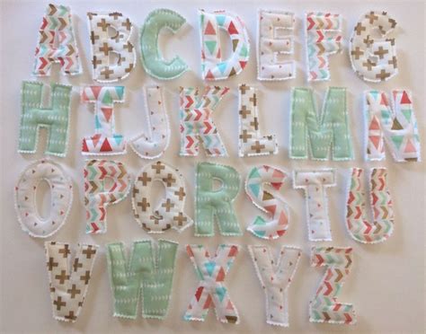 The Letters Are Made Out Of Fabric And Have Different Designs On Them