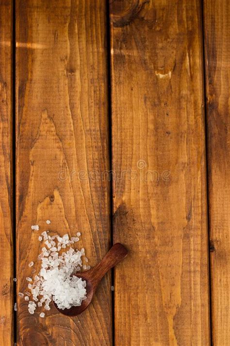 Salt In A Wooden Spoon On A Wooden Table Large Pieces Of Salt In A