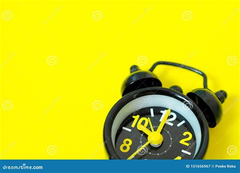 Vintage Black Alarm Clock Isolated On Yellow Background With Space For