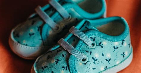 Photo of a Blue Baby Shoes Made on an Orange Background · Free Stock Photo