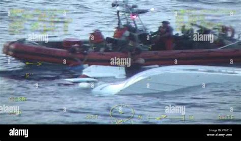 A Coast Guard Cutter William Flores Small Boat Crew Pulls Two People