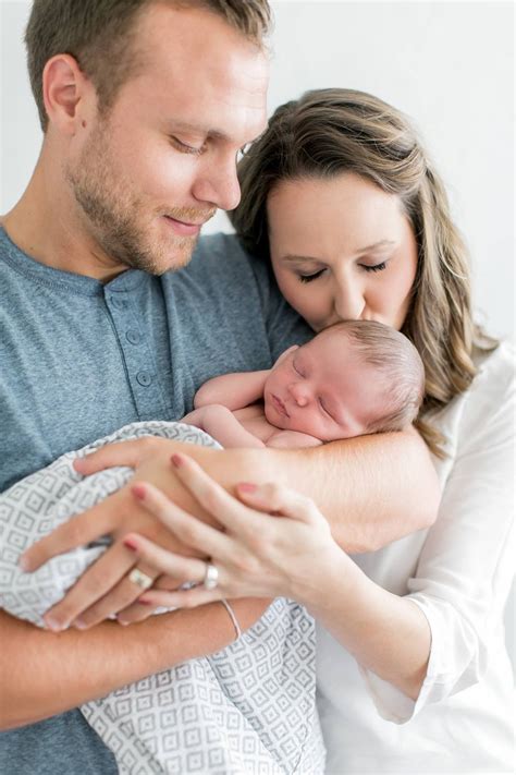 Daddy Holding Baby And Mom Behind Him Kissing Baby Newborn