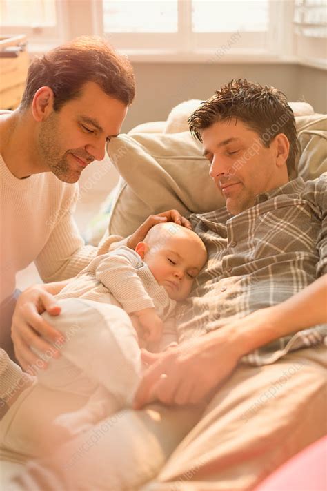 Male Gay Parents Watching Baby Son Sleeping Stock Image F018 5607 Science Photo Library