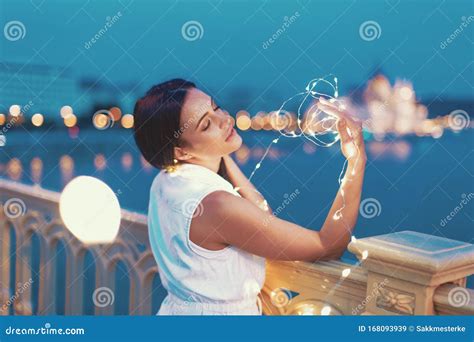 Sensual Brunette Woman Playing With Fairy Lights Outdoors Stock Image Image Of Cinematic