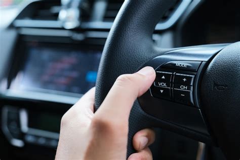 Premium Photo A Car Driver Hand Adjusting The Sound Volume Using