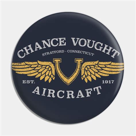 a button with the words chance voghtt and wings on it, in gold