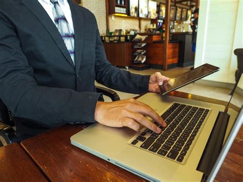 Premium Photo Man Using Mobile Phone While Sitting On Table