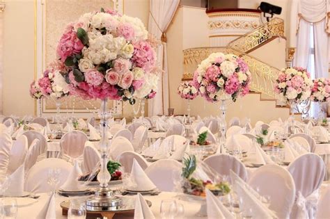 The Tables Are Set With White And Pink Flowers