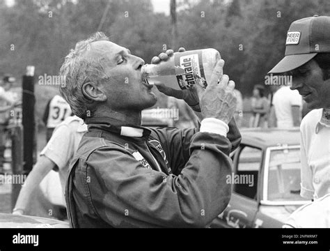 Driver Actor Paul Newman Takes A Long Cool Drink Before Mounting The