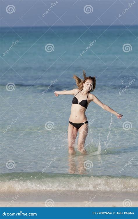 Woman With Bikini Jumping In The Sea Hochformat Stock Photo Image Of