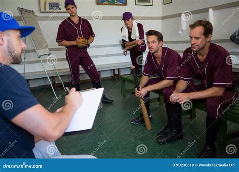 Baseball Team Planning with Coach while Sitting on Bench Stock Photo ...