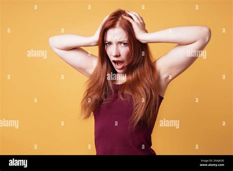 Frustrated Angry Young Woman Holding Her Head Screaming Stock Photo Alamy