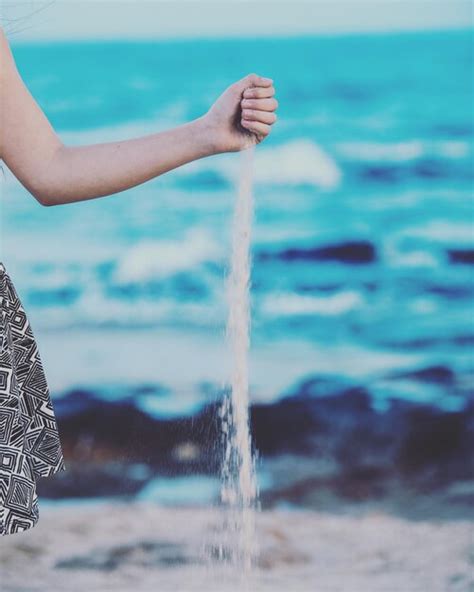 premium photo cropped hand  woman spilling sand  beach