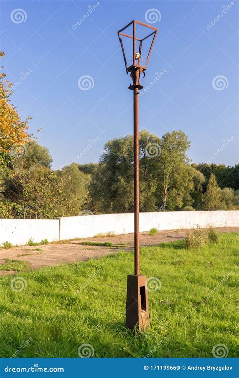 Old Street Lamp With Broken Light Bulb And Torn Electrical Wires On