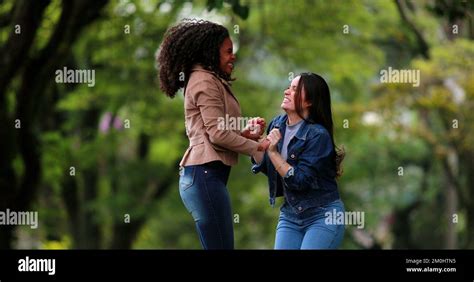 Fun Happy Two Diverse Girlfriends Jumping And Dancing In Joy People