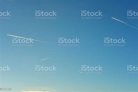 Airplane Flying In High Altitude Leaving Contrail Stock Photo