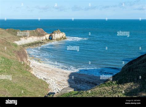 White Chalk Cliffs Around A Small Beach And Bay At Flamborough Head