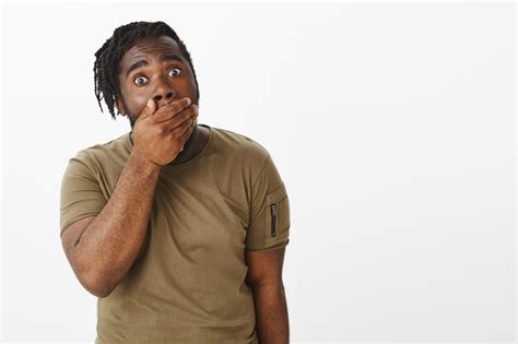 Free Photo Studio Shot Of Shocked Guy In A Brown T Shirt Posing