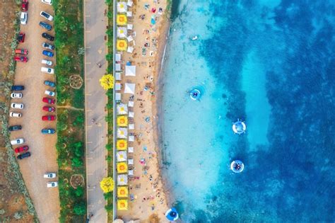 premium photo aerial view  sandy beach  umbrellas blue sea