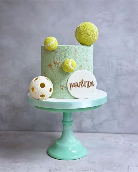 A Green Cake With Tennis Balls On Top And The Word Marathon Written In