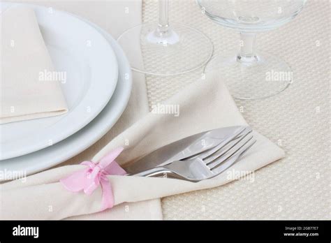 Table setting with fork, knife, plates, and napkin Stock Photo - Alamy