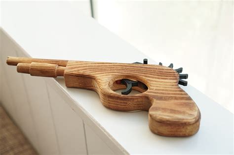 The Picture Shows A Collection Of Handmade Antique Wooden Gun Displayed In The Living Room Stock