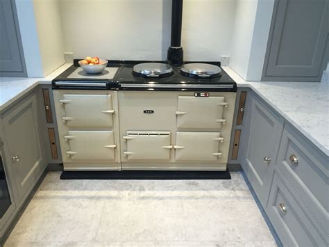 Cream Aga With Grey Marble Floor And Oak Insert Chopping Boards Trays