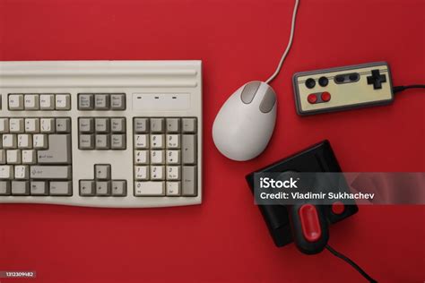 Old Keyboard Joystick Gamepad And Mouse On Red Background Retro Gaming